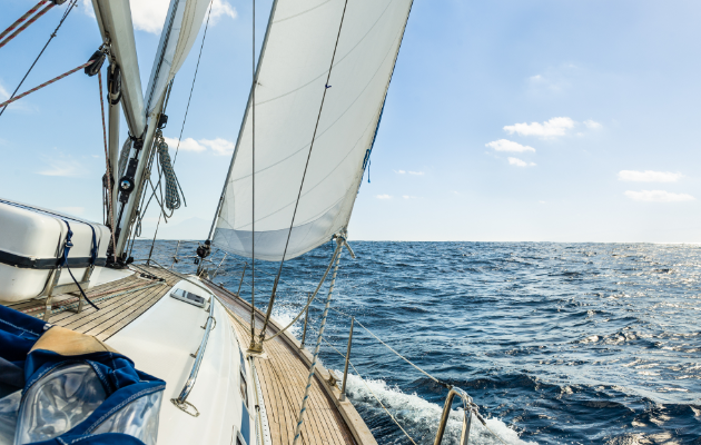 Sail boat in the open ocean Sail boat in the open ocean